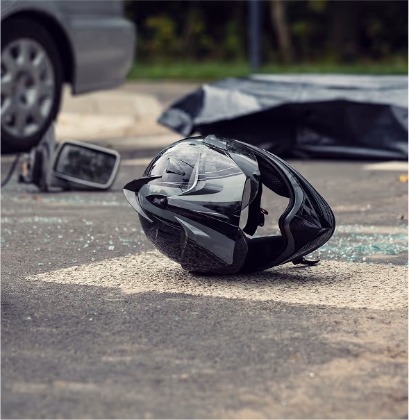 Motorcycle helmet on road after intersection collision.
